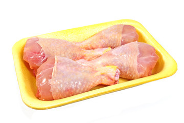 Raw chicken legs in plastic bowl isolated on white