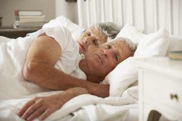 Senior Woman Tries To Be Affectionate Towards Husband In Bed