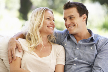 Naklejka premium Couple Relaxing On Sofa At Home