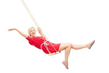 Joyful woman swinging on a swing - obrazy, fototapety, plakaty
