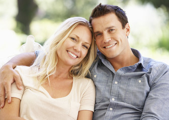 Naklejka premium Couple Relaxing On Sofa At Home