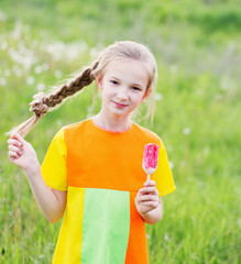 little girl eats ice-cream in the summer