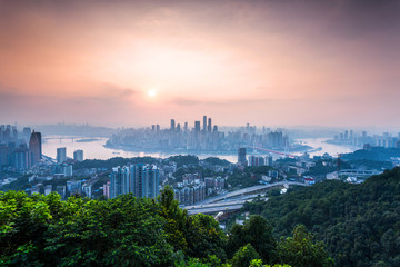 Fototapeta premium skyline and landscape of chongqing at riverbank during sunrise.