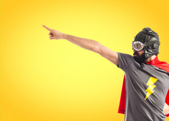 Super hero pointing to the lateral