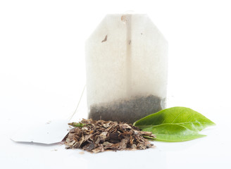 Tea bag with leaves isolated on white background
