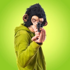 Monkey man shooting with a pistol