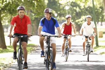 Group Of Men On Cycle Ride Through Park