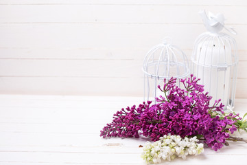 Lilac flowers  and candles on wooden background.
