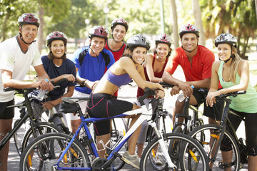 Group Of Cyclists Resting During Cycle Ride Through Park