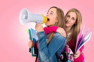 Students shouting by megaphone over white background
