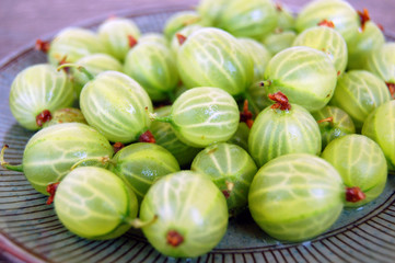 fresh fruits background with gooseberries on rustic wooden table
