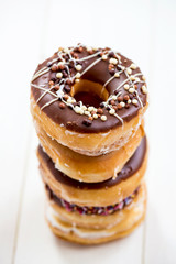 Stack of Glazed Doughnuts with colourful sprinkles, chocolate, i