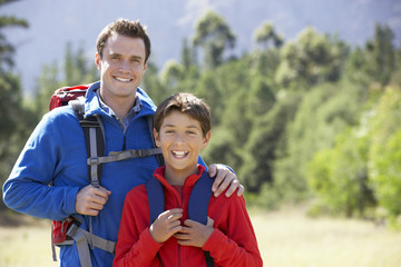 Portrait Of Father And Son On Hike In Beautiful Countryside