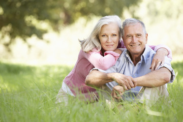 Fototapeta premium Senior Couple Relaxing In Sunny Summer Field