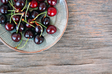 fresh fruits background with sweet cherries on rustic wooden table