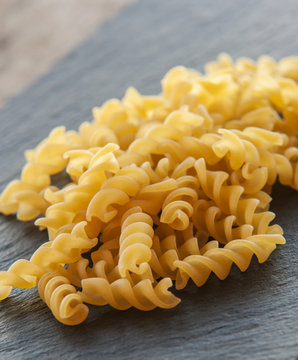 Raw pasta isolated on black (spiral shaped) close up