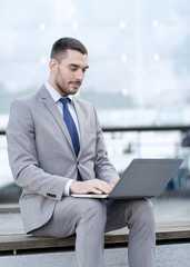 businessman working with laptop outdoors