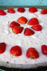 background with raw strawberry cake on rustic wooden table