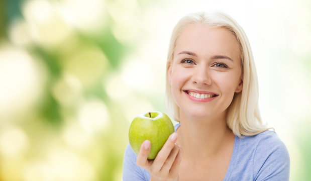 Happy Woman Eating Green Apple