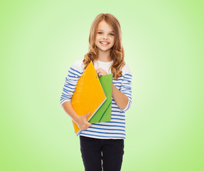 happy girl holding colorful folders