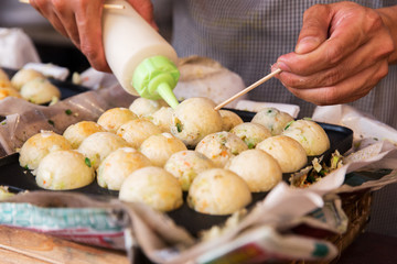 cook stuffing dough or rice balls at street market