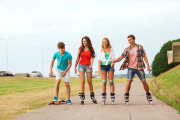 group of smiling teenagers with roller-skates
