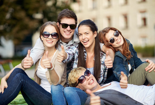 group of students or teenagers showing thumbs up
