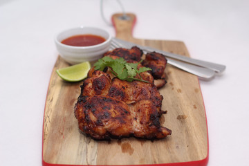 Grilled spicy chicken thighs with lime and sweet chilli sauce