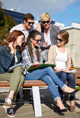 group of happy students with notebooks at campus