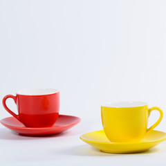 Yellow and red cup set on table.