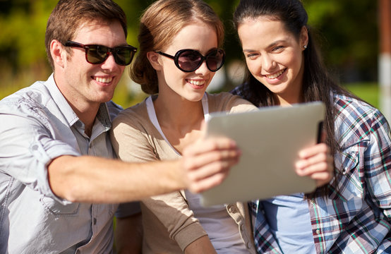 students or teenagers with tablet pc taking selfie