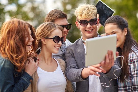 students or teenagers with tablet pc taking selfie