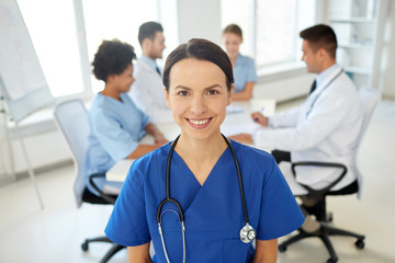 happy doctor over group of medics at hospital