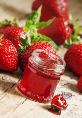 Fresh homemade strawberry jam with berries in small jars, select