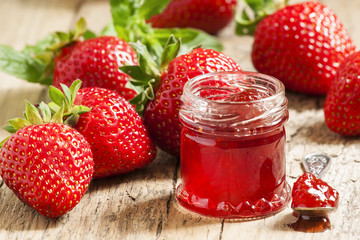 Fresh homemade strawberry jam with berries in small jars, select