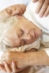 Obraz na płótnie Canvas Senior Couple Sleeping In Bed