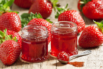 Fresh homemade strawberry jam with berries in small jars, select