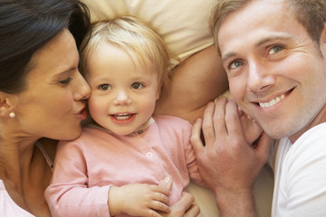 Family Relaxing In Bed