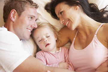 Fototapeta premium Family Relaxing In Bed