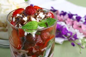 Healthy layered  desserts with fresh strawberries and cream on wooden 