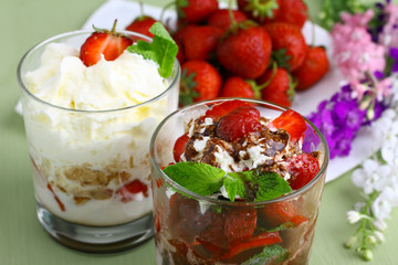 Healthy layered  desserts with fresh strawberries and cream on wooden 