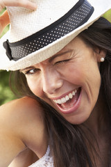 Head And Shoulders Portrait Of Smiling Woman With Sun Hat