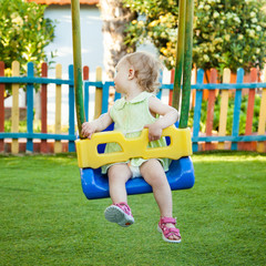 Fototapeta na wymiar Little girl on the swing