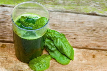 Spinach smoothie on old rustic table