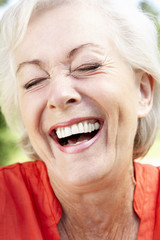 Head And Shoulders Portrait Of Laughing Senior Woman