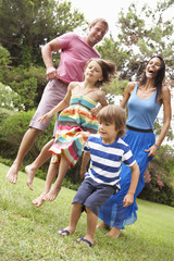 Fototapeta premium Family Playing In CountrysideTogether