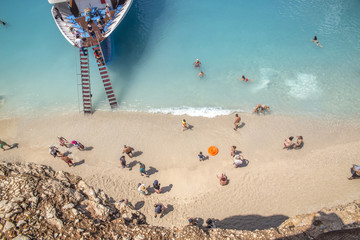 cruise ship, ladder, people on the beach, swimming