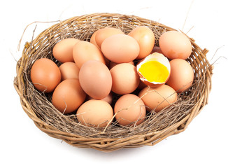 Chicken eggs in the nest of straw.