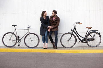 Obraz premium Young couple standing against the wall and hugging