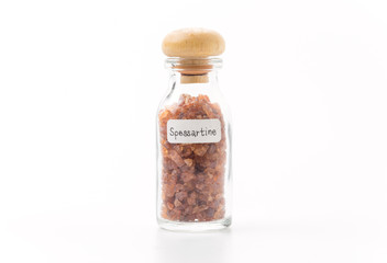 spessartine in glass bottle isolated
